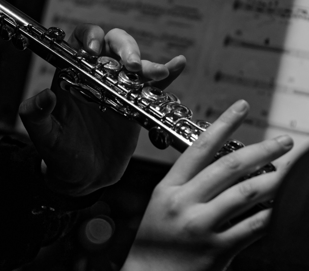 Close-up of a musician playing a silver flute